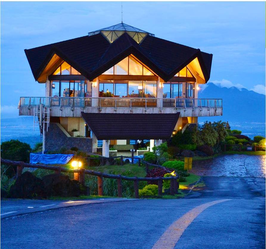 Tagaytay Highlands pavilion illuminated at dusk overlooking the mountain landscape