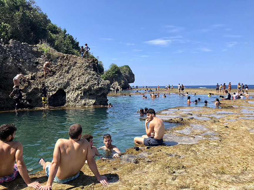 Siargao rock pools during dry season Philippines with clear water and swimmers enjoying calm conditions