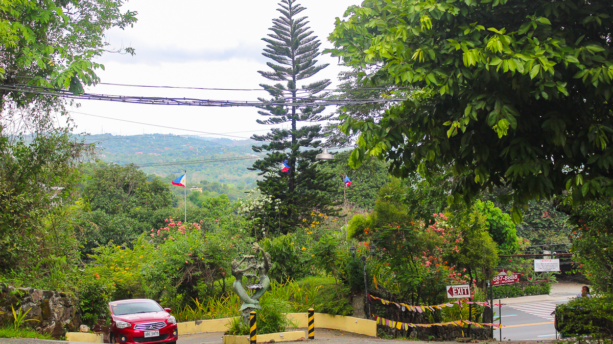 Cloud 9 Antipolo entrance area with parking spaces, landscaped gardens, and views of the surrounding Rizal hills
