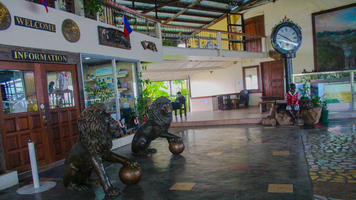 Information area at Cloud 9 Antipolo featuring lion statues, visitor services, and the main reception entrance.