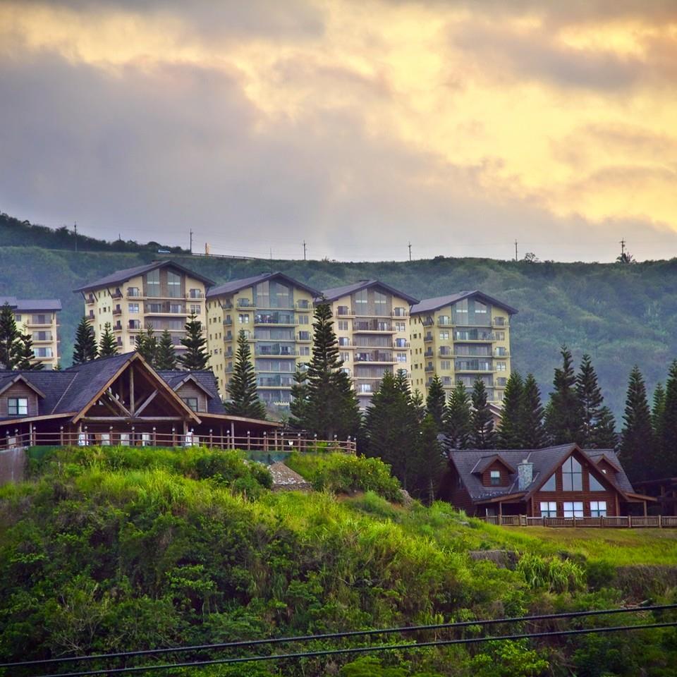 Modern condominium buildings overlooking the hills of Tagaytay Highlands