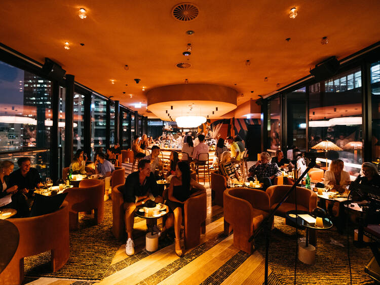 Australian slang mate meaning social interaction pub bar nightlife conversation Australia people dining in warm modern restaurant setting illustrating tone and context in language