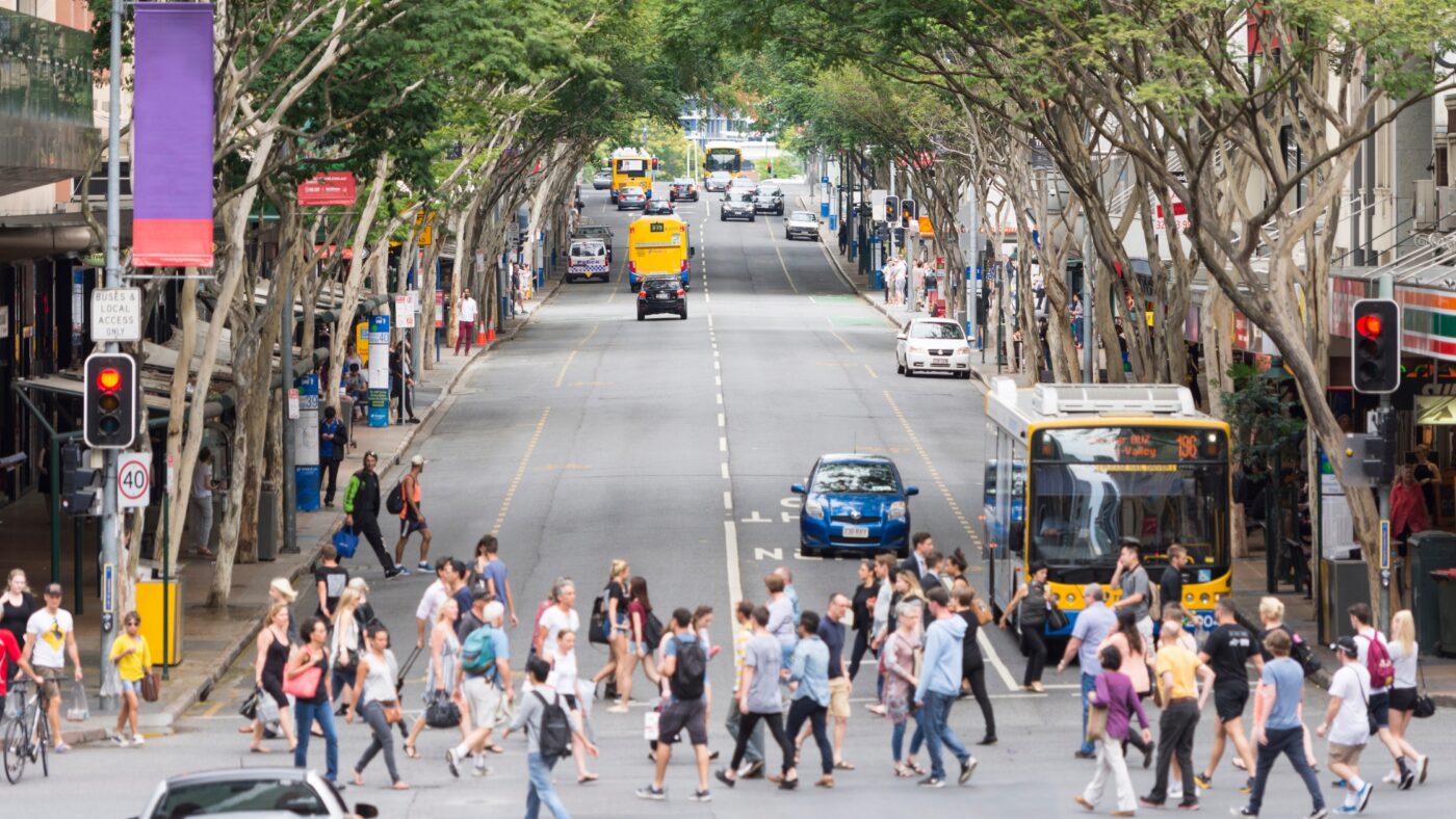 Moving to Australia — everyday life on a busy Brisbane city street, people crossing at a pedestrian intersection