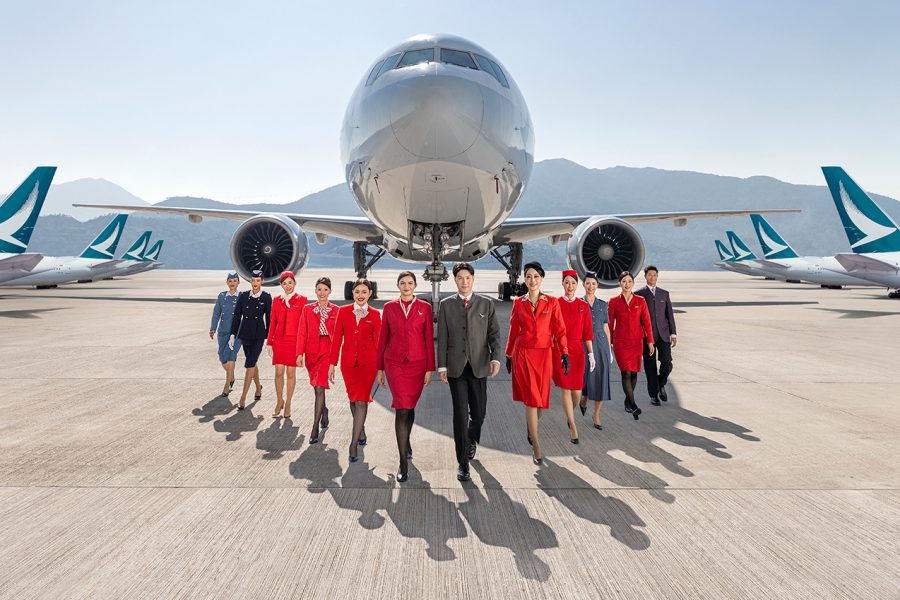 Cathay Pacific hot air hostess uniform showing professional cabin crew walking in coordinated airline presentation