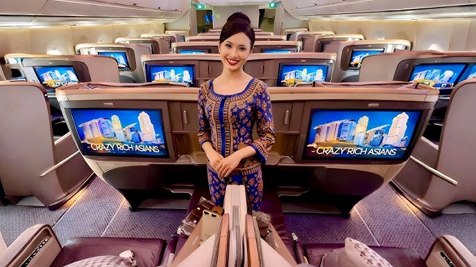 Hot air hostess Singapore Airlines cabin crew in business class cabin showcasing premium service and refined presentation