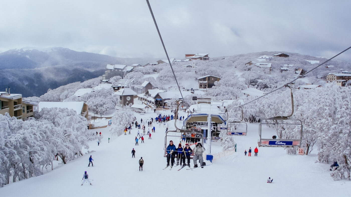 Australian Alps: The Misunderstood Snow Country Hiding in Plain Sight Australian Alps winter village with snow-covered mountains, chairlifts and skiers in Australia's Snowy Mountains