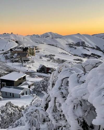 Australian Alps ski resort surrounded by snow-covered mountains at sunrise