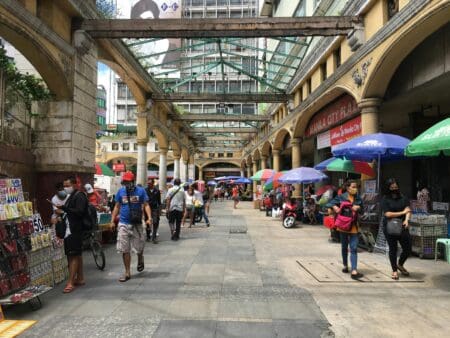 Busy street scene in Quiapo Manila showing dense crowd, street vendors, and urban chaos in the Philippines