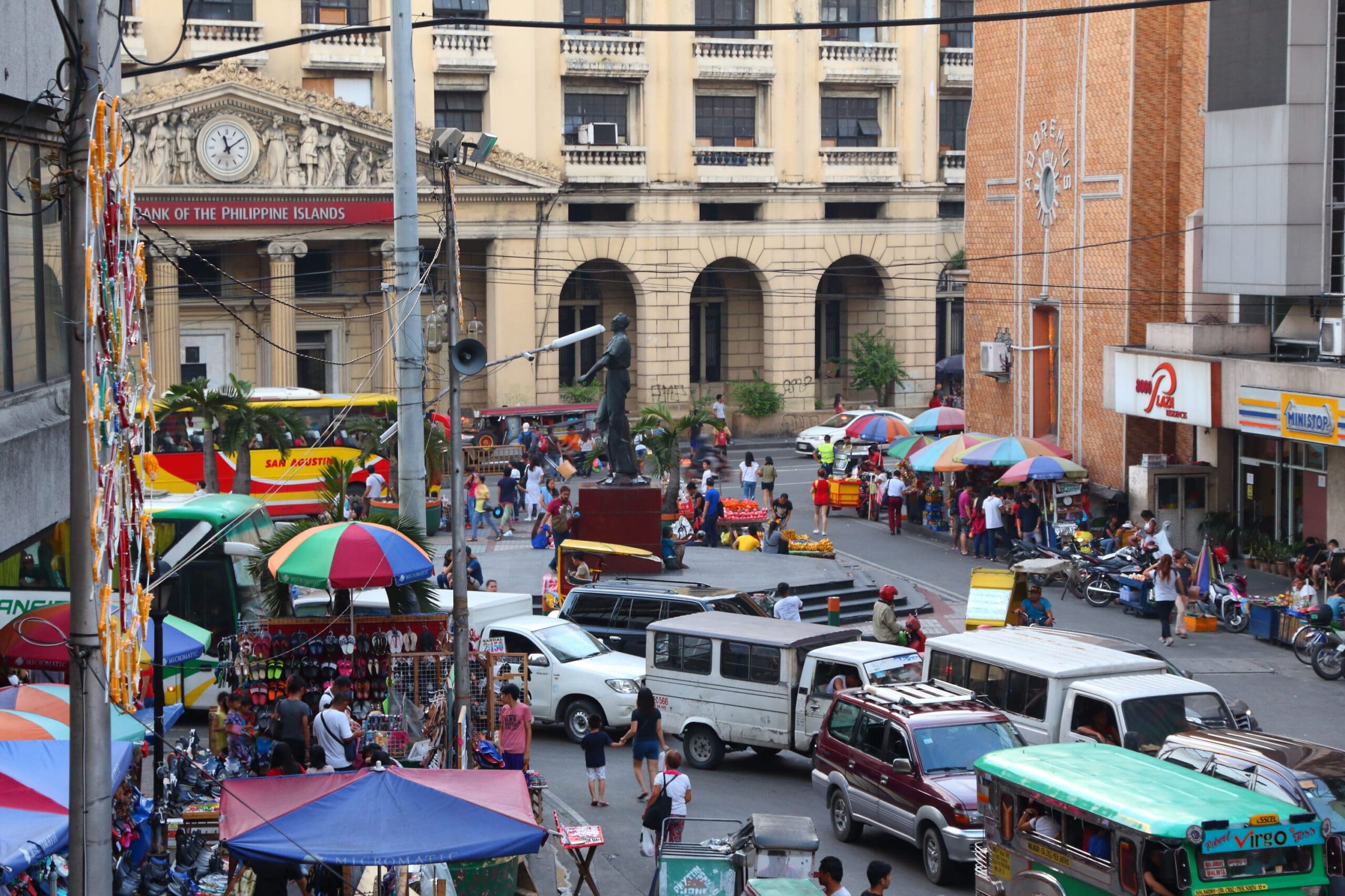 Everyday street scene with colorful umbrellas in a Philippine neighborhood market - deeper Philippines travel insights