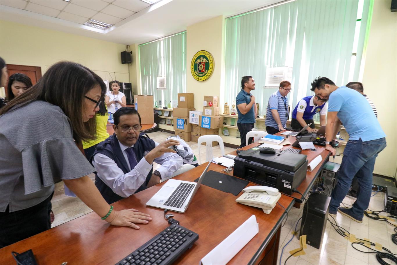 Philippine bureaucracy office staff handling administrative work inside a government department.