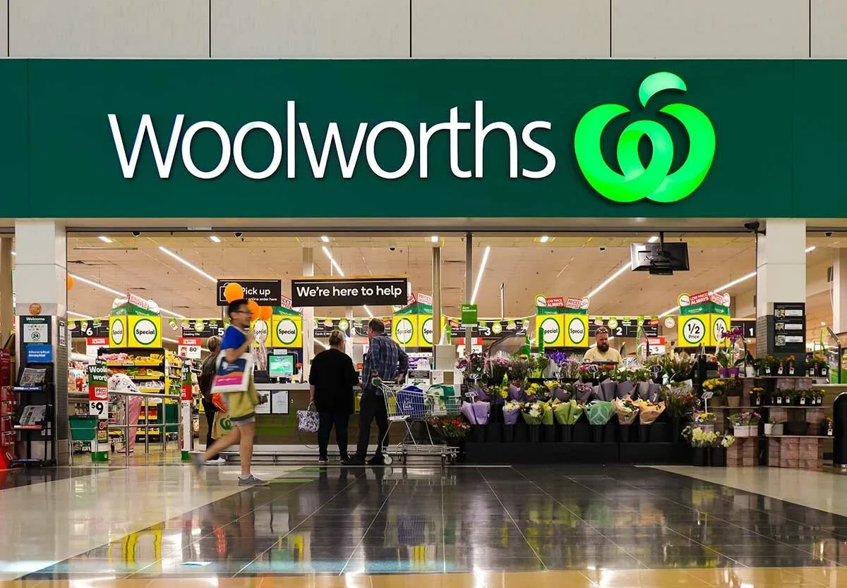 Interior aisle of a Woolworths supermarket in Australia with fresh produce and groceries, illustrating grocery costs and budget considerations for the cost of living in Australia for migrants.