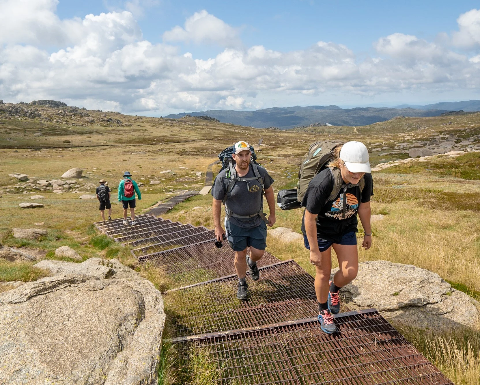 Hikers on the elevated walkway to Mount Kosciuszko summit from Thredbo